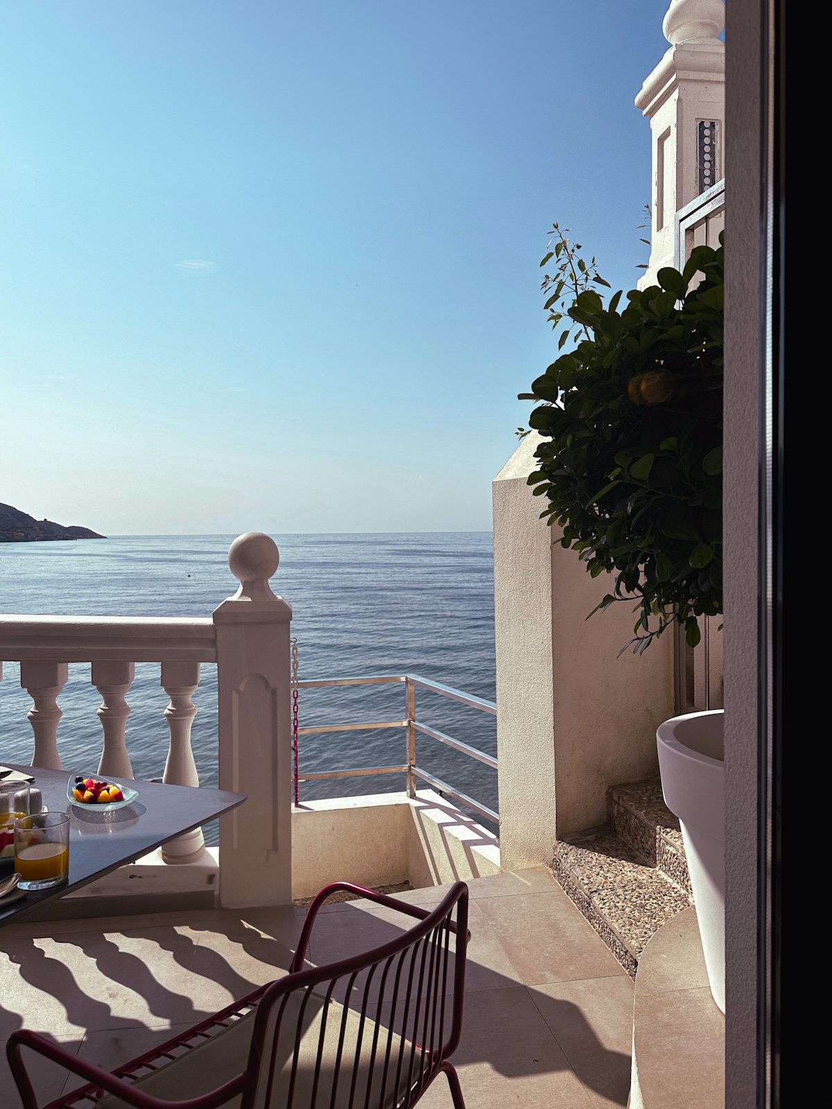 Terrasse privée avec table et chaises donnant sur la mer